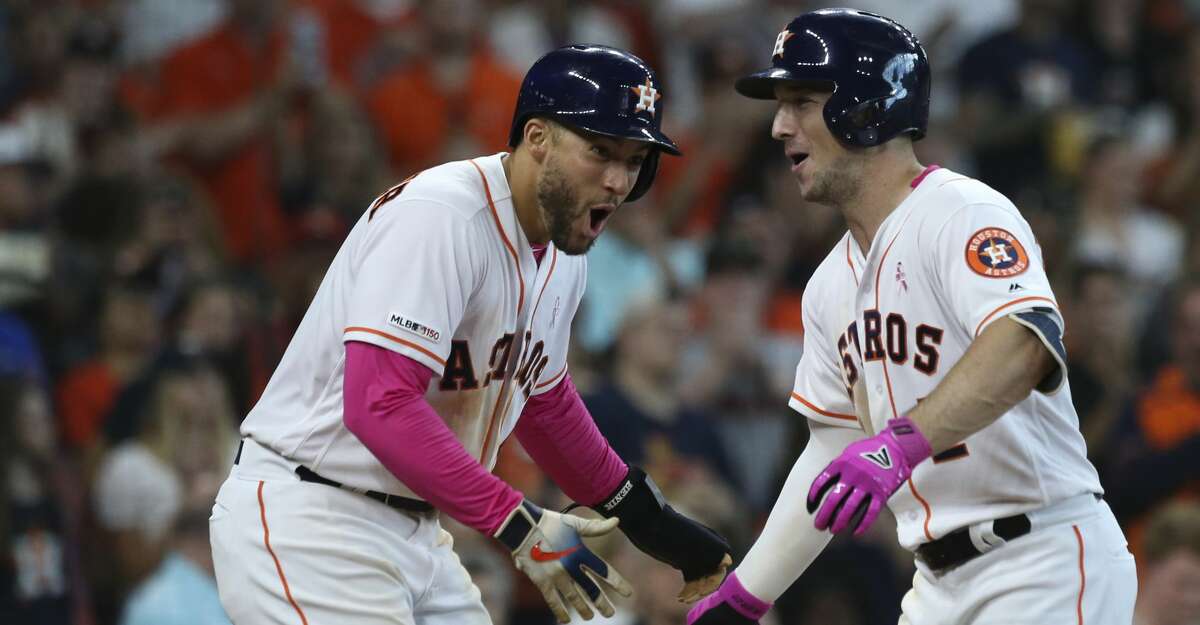 Houston Astros third baseman Alex Bregman (2) celebrates his three-run home run with George Springer (4) during the bottom fifth inning at Minute Maid Park on Sunday, May 12, 2019, in Houston.