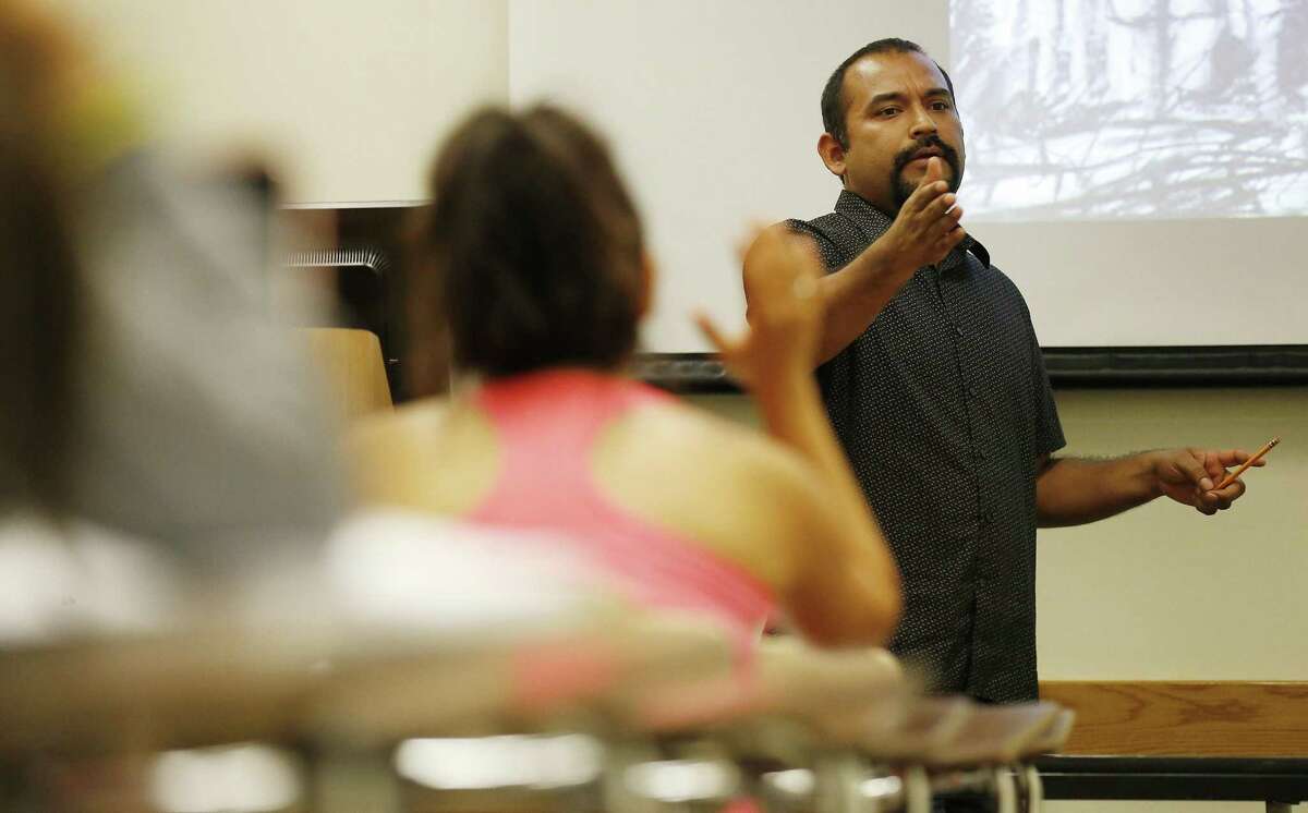 UTSA professor Marco Cervantes teaches the class, Mexican Americans in the Southwest, at the university's main campus on Thursday, Aug. 28, 2015. Cervantes also uses his ability to rap to teach culture and customs in his Mexican Studies course. (Kin Man Hui/San Antonio Express-News)