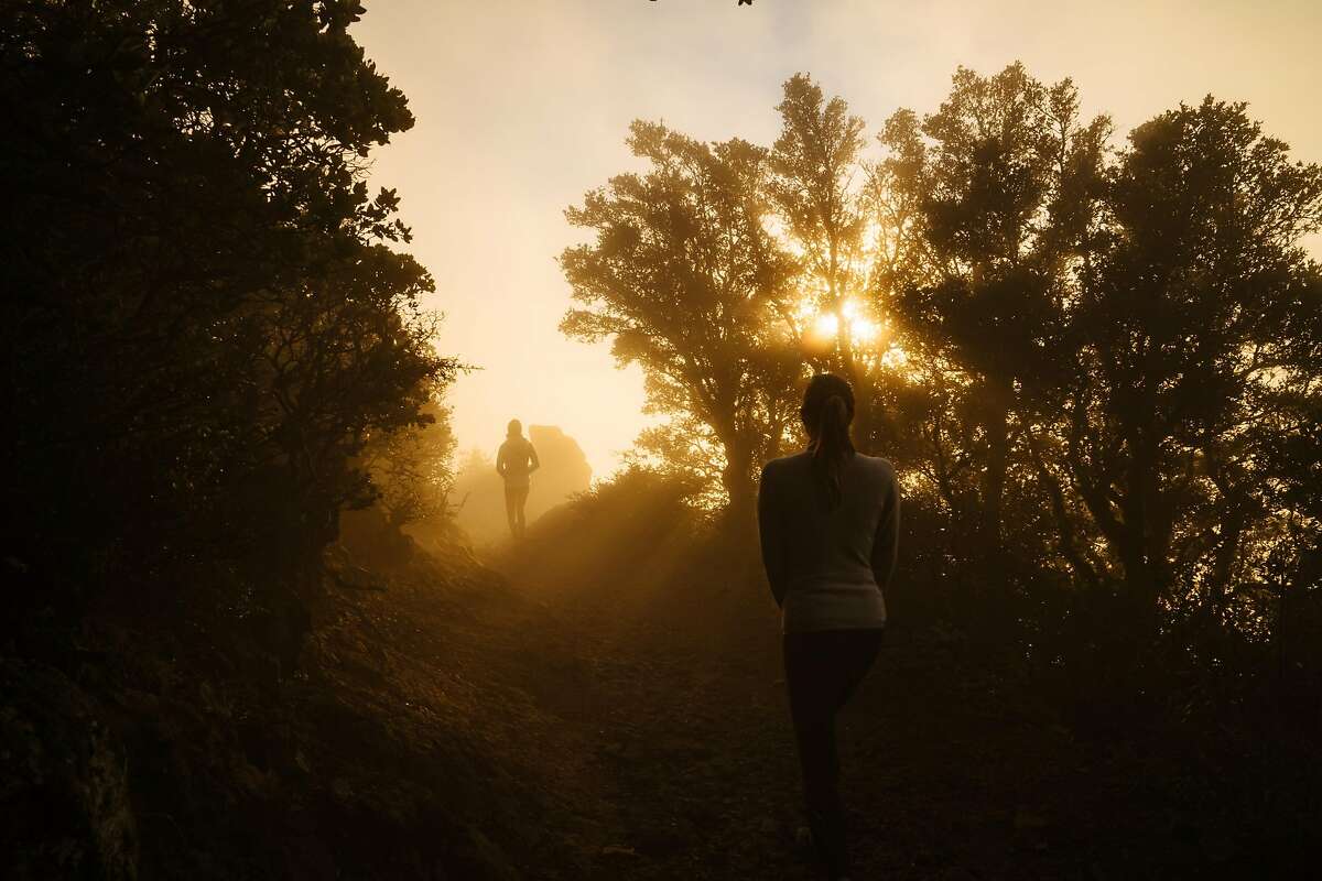 Ashley Meyers and Britt Williams Baker hike down East Peak at Mount Tamalpais State Park in Mill Valley, Calif., on Wednesday, Dec. 19, 2018.