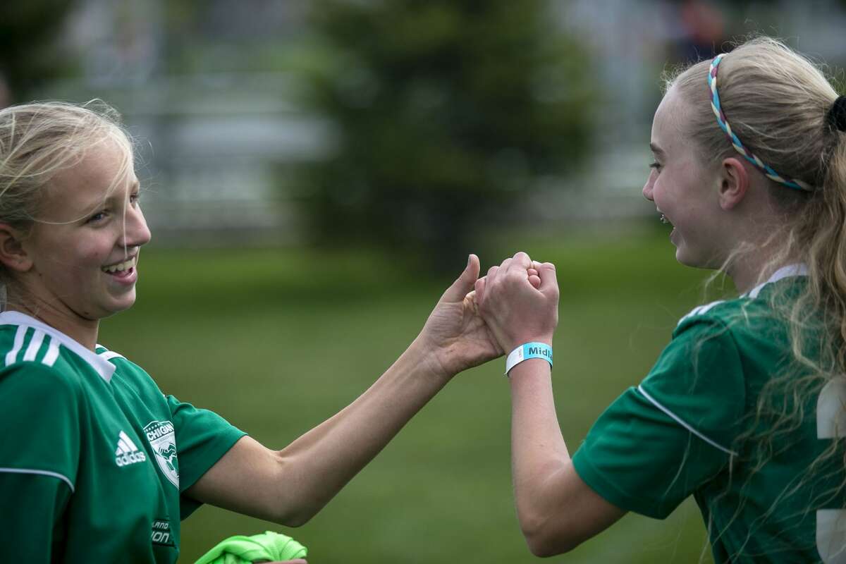 Midland Fusion 06's Rachael Ieuter and Carley Gatrell shake hands before their game against La Forza 06 Blue during the 37th annual Midland Invitational Tournament at the Midland Soccer Club in Midland on Saturday, May 11, 2019.