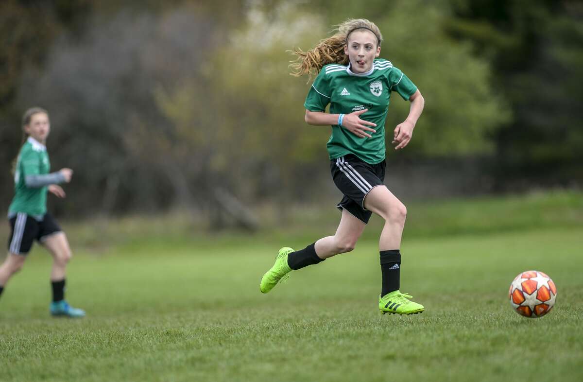 Midland Fusion 06's Grace Hall is suspended in air as she goes after the ball during their game against La Forza 06 Blue during the 37th annual Midland Invitational Tournament at the Midland Soccer Club in Midland on Saturday, May 11, 2019. (Josie Norris/for the Daily News)