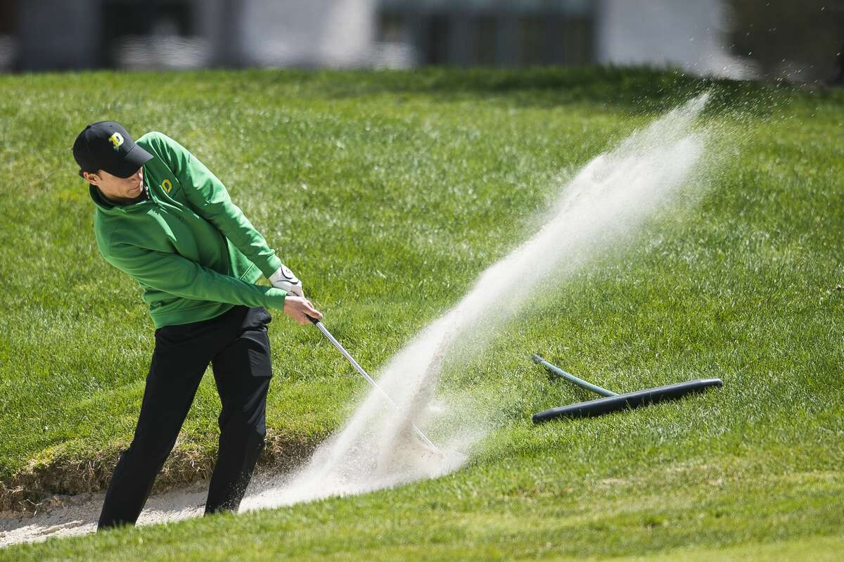Dow's Trevor McIntyre chips out of a sand trap during the Chemical City Classic golf tournament on Monday, May 13, 2019 at the Midland Country Club. (Katy Kildee/kkildee@mdn.net)