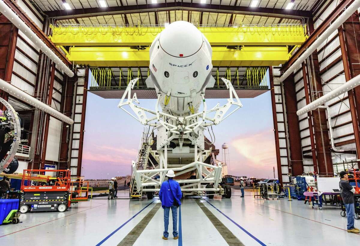 This photo obtained from NASA shows the SpaceX Falcon 9 rocket with the company’s Crew Dragon attached, rolling out of the company’s hangar at NASA Kennedy Space on Jan. 3, 2019.