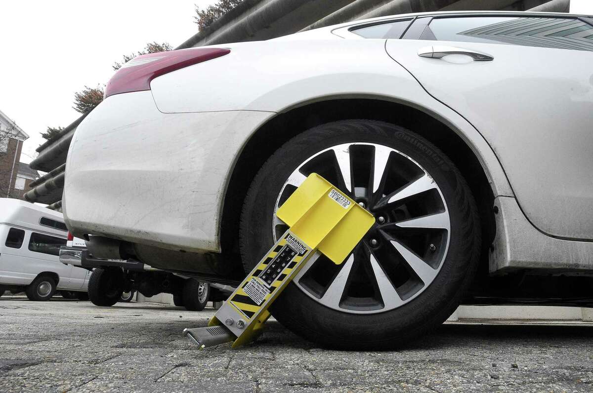 A vehicle is disabled with a new self-releasing electronic boot in Stamford.