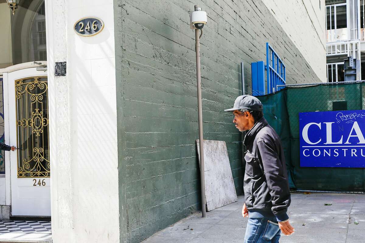 A man passes by a security camera on McAllister Street in San Francisco, California, on Monday, May 13, 2019. The Board of Supervisors is considering a proposal to ban city departments from using facial recognition software. While privacy advocates applaud the move, others say it will keep the city from a useful tool in crime solving. San Francisco law enforcement agencies such as the police department and District Attorney's office, say they do not use facial recognition software.
