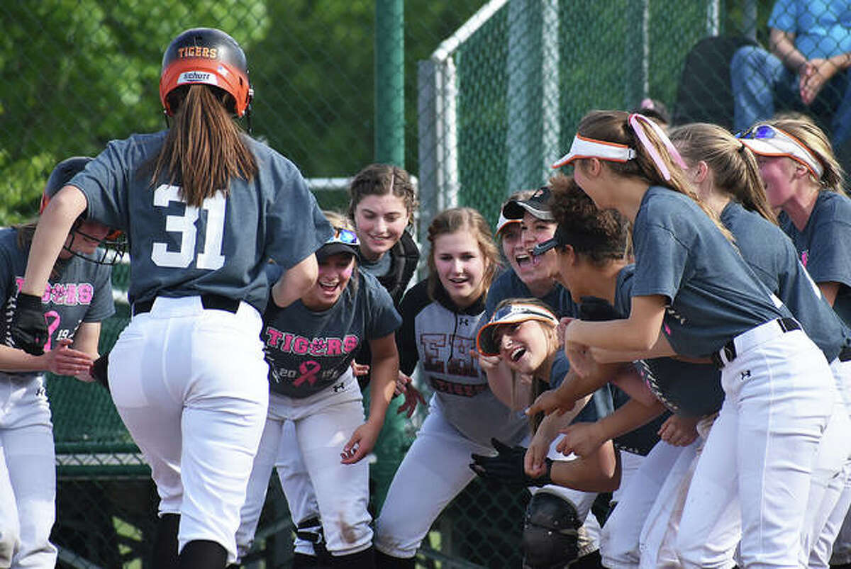 Edwardsville first baseman Mackenzie Owens is greeted at the plate by her teammates after hitting a two-run homer in the fourth.