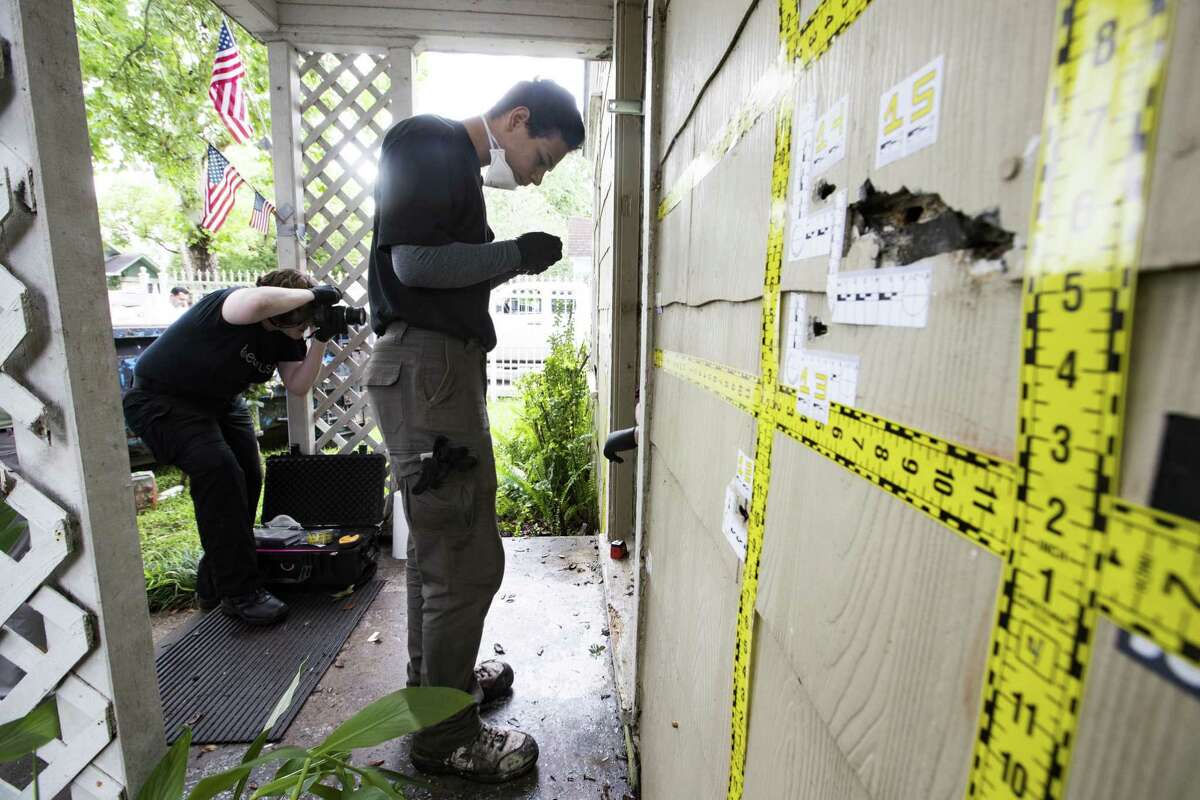 Out of state forensic team brought by the family of the killed homeowners at a botched drug raid work the bullet holes still at the home on 7815 Harding on Friday, May 10, 2019, in Houston. The home was the scene of a botched drug raid that took place on Jan. 28, 2019 and left the two homeowners dead and five police officers injured.