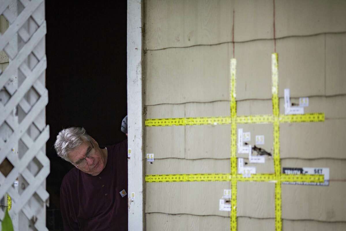 An out of state forensic analyst brought by the family of the killed homeowners at a botched drug raid work the bullet holes still at the home on 7815 Harding on Friday, May 10, 2019, in Houston. The home was the scene of a botched drug raid that took place on Jan. 28, 2019 and left the two homeowners dead and five police officers injured.