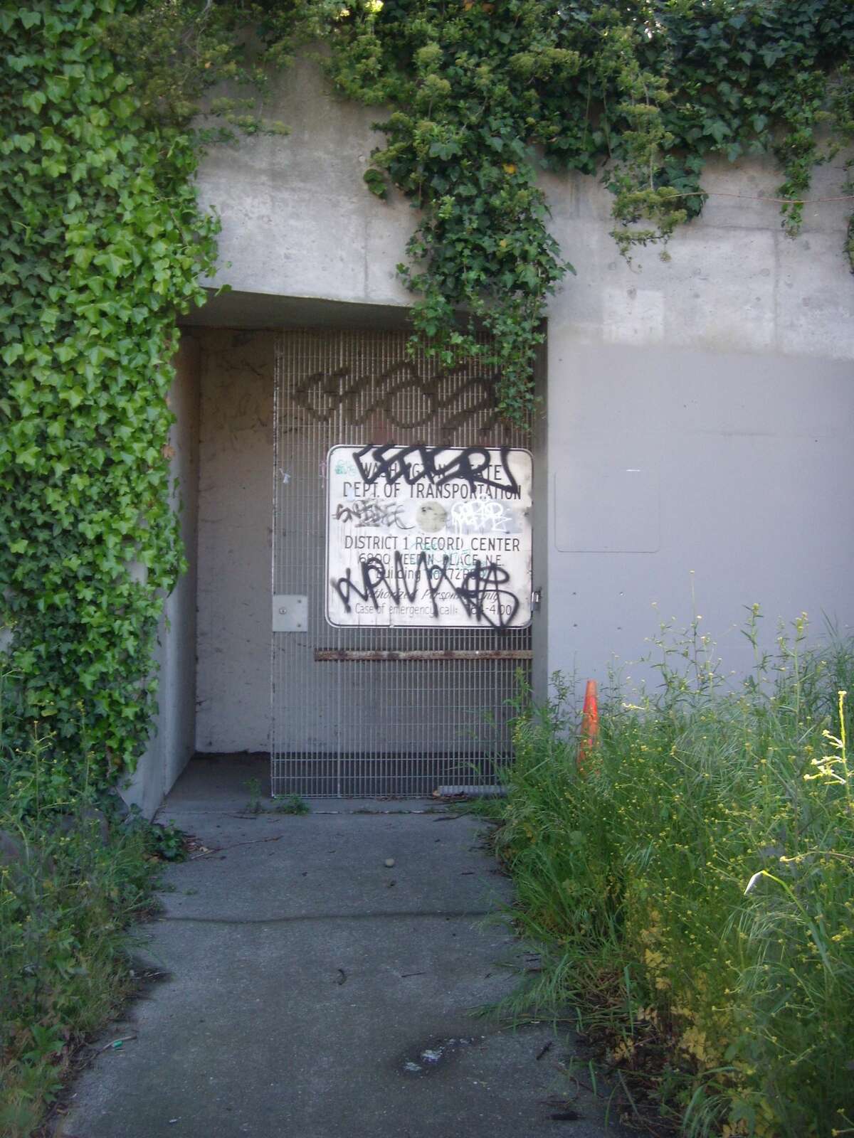 WSDOT's caption: If you've ever walked by this nondescript gate on Weedin Place in Seattle, you might have thought it was just another WSDOT storage facility. Inside, you'll find the only fallout shelter built into a highway anywhere in the nation.