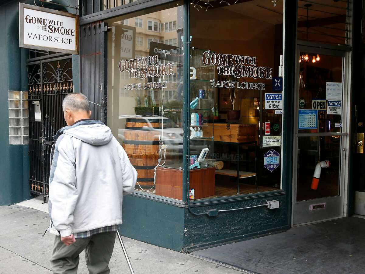 A man walks past the Gone With the Smoke Vapor Lounge on Geary Street in San Francisco, Calif. on Thursday, May 9, 2019. Chris Chin would be forced to shut down his business if proposed legislation is passed banning the sale of e-cigarettes in the city.