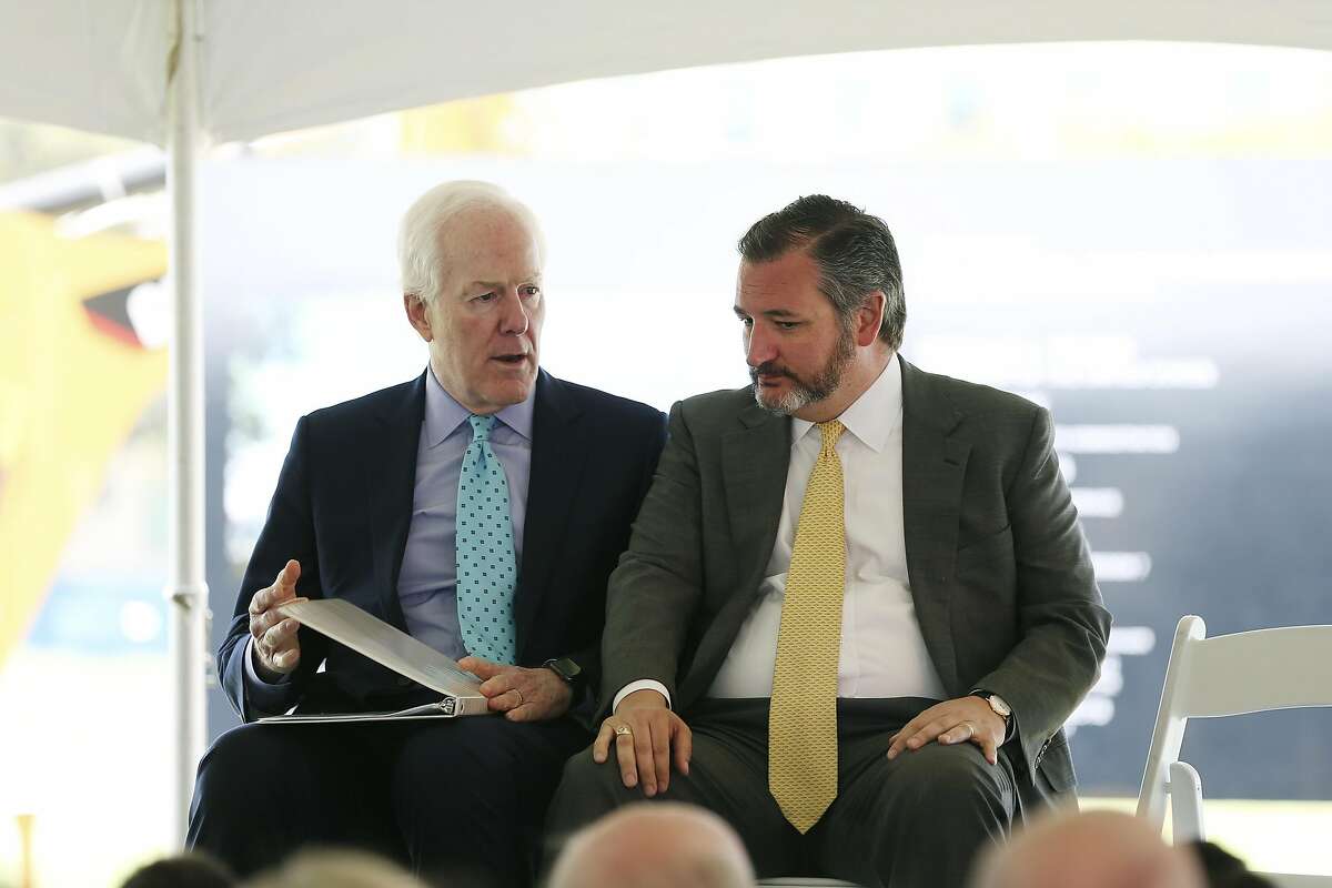 U.S. Sen. John Cornyn, left, talks with fellow Sen. Ted Cruz before the start of a ground breaking ceremony for the US Courthouse at the former site of the San Antonio Police Department on the 200 block of West Nueva Street, Monday, March 18, 2019.