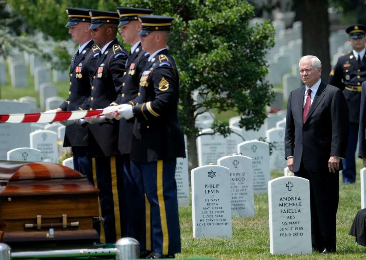 Defense Secretary Robert Gates watches during funeral services of Army Pfc. David Taylor Miller at Arlington National Cemetery in Arlington, Va., Wednesday, July 28, 2010. (AP Photo/Susan Walsh)