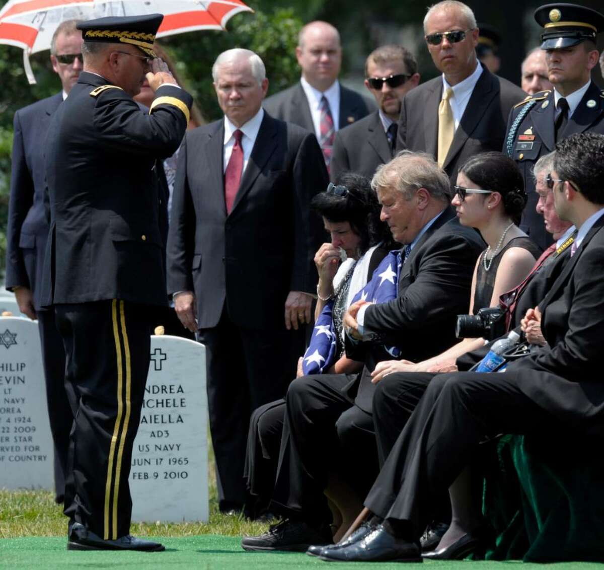Defense Secretary Robert Gates, center, watches as Maj. Gen. Richard Formica, left, salutes greets Leslie Miller, seated left, and Jesse Miller, seated second from left, parents of Army Pfc. David Taylor Miller, during his funeral service at Arlington National Cemetery in Arlington, Va., Wednesday, July 28, 2010. Miller of Wilton died June 21 in Afghanistan. (AP Photo/Susan Walsh)