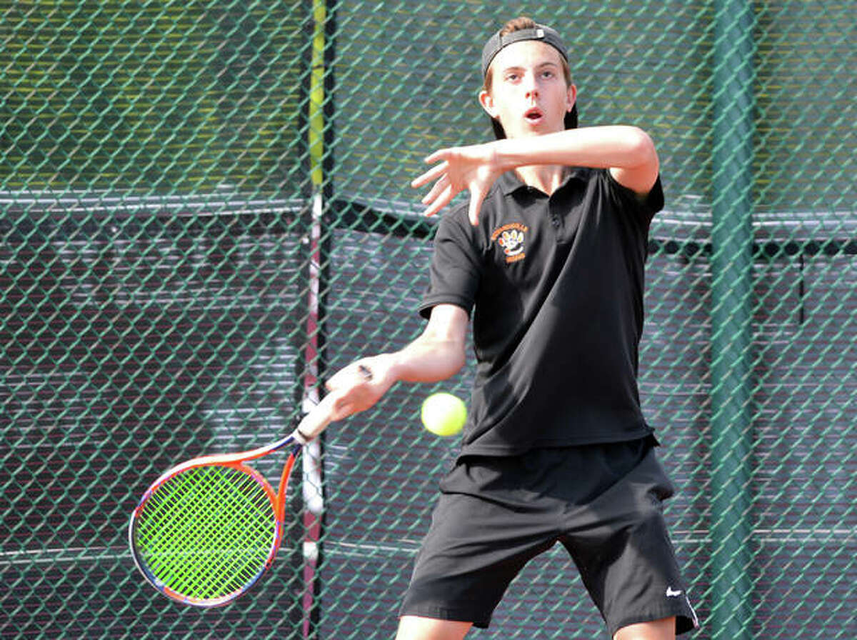 Edwardsville senior Drake Schreiber returns a shot in his No. 2 doubles match during Tuesday’s Southwestern Conference dual match at Belleville West.