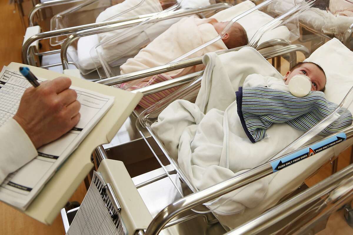 FILE - This Feb. 16, 2017 file photo shows newborn babies in the nursery of a postpartum recovery center in upstate New York. According to a government report released Wednesday, May 15, 2019, U.S. birth rates reached record lows for women in their teens and 20s, leading to the fewest babies in 32 years. (AP Photo/Seth Wenig, File)