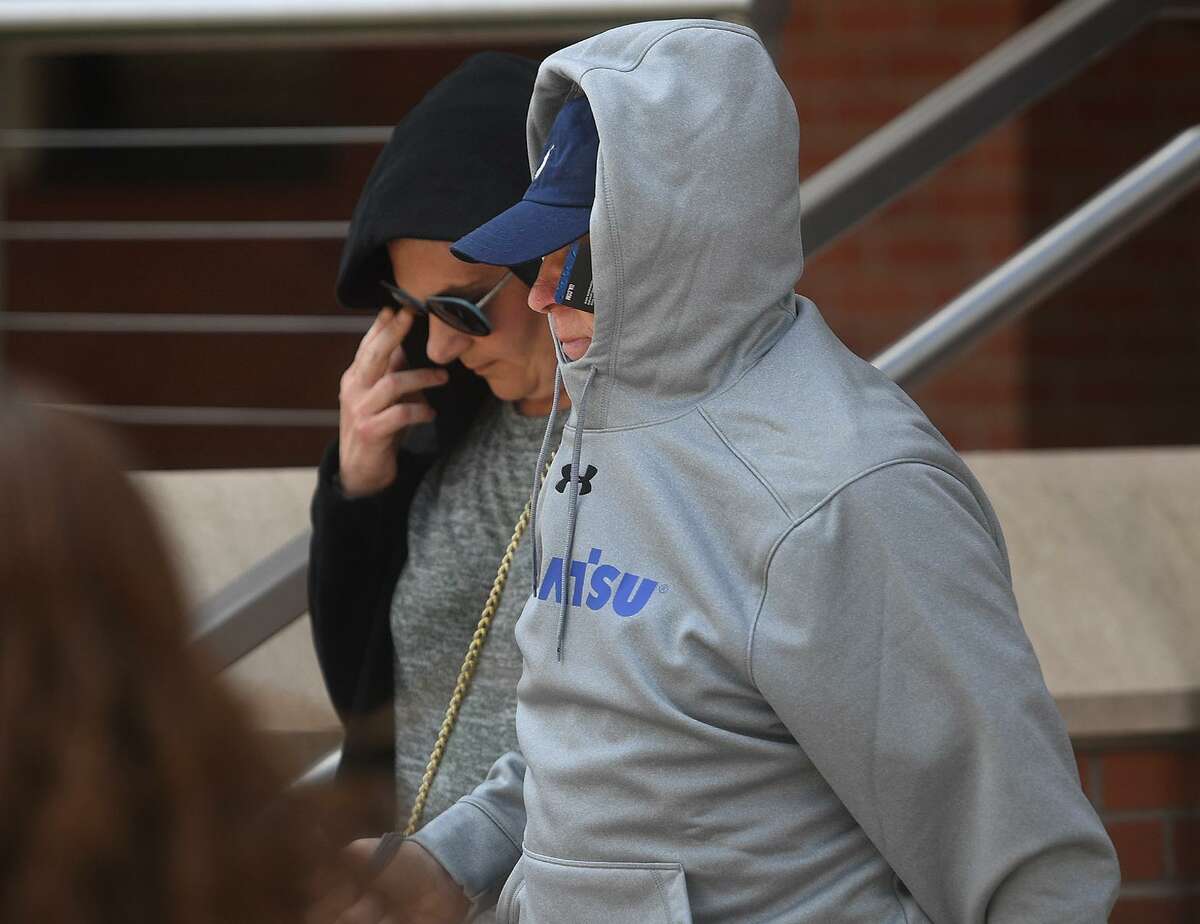 Accused killer James Taylor attempts to hide his identity as he exits Superior Court in Bridgeport, Conn. on Wednesday, May 15, 2019 after posting a $2 million bond for the February 3rd murder of his ex-wife Catherine Taylor.