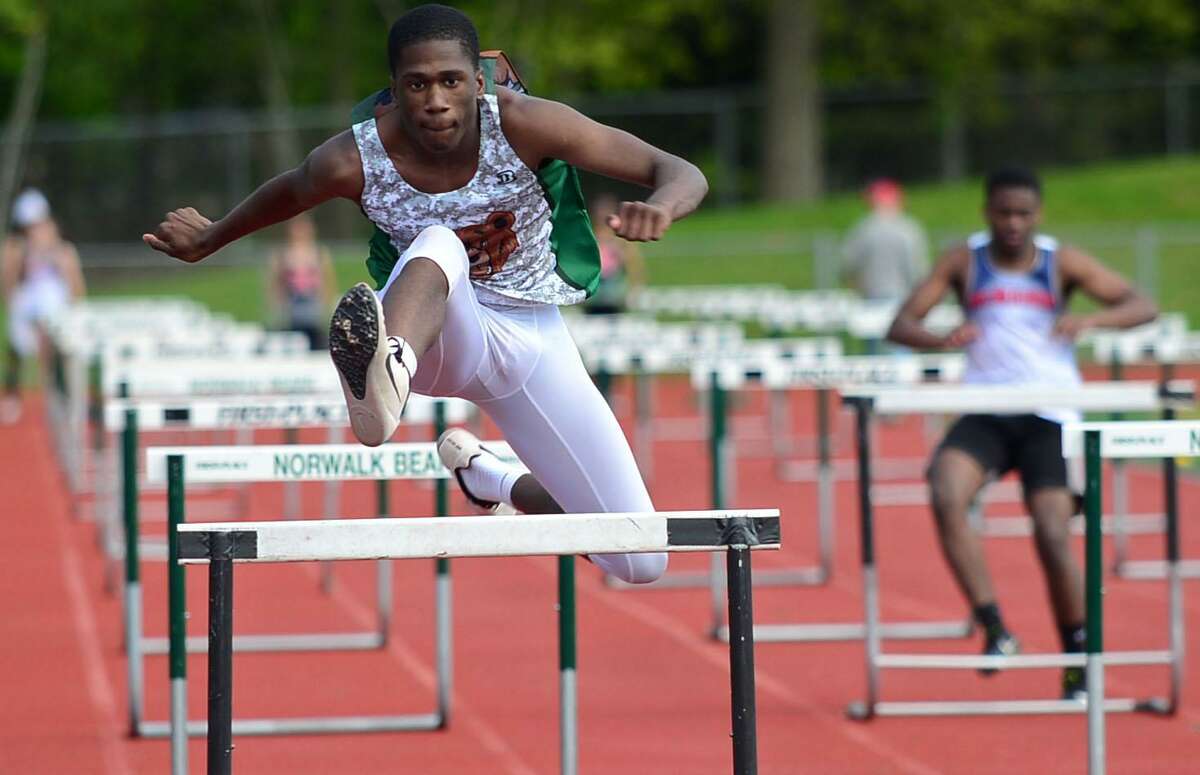 Bears Tahzir Fulton competes in the 100m hurdles as the Brien McMahon High School Senators take on the Norwalk High Schools Bears in the intra-city track meet Wednesday, May 15, 2019, at Norwalk High School in Norwalk, Conn.