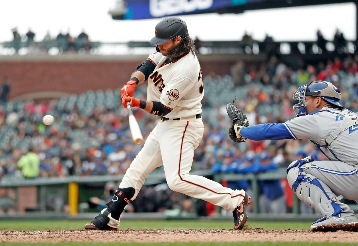 San Francisco Giants' Pablo Sandoval, right, strikes out during the first  inning of the team's baseball game against the Miami Marlins, Wednesday,  May 29, 2019, in Miami. At left is Marlins catcher