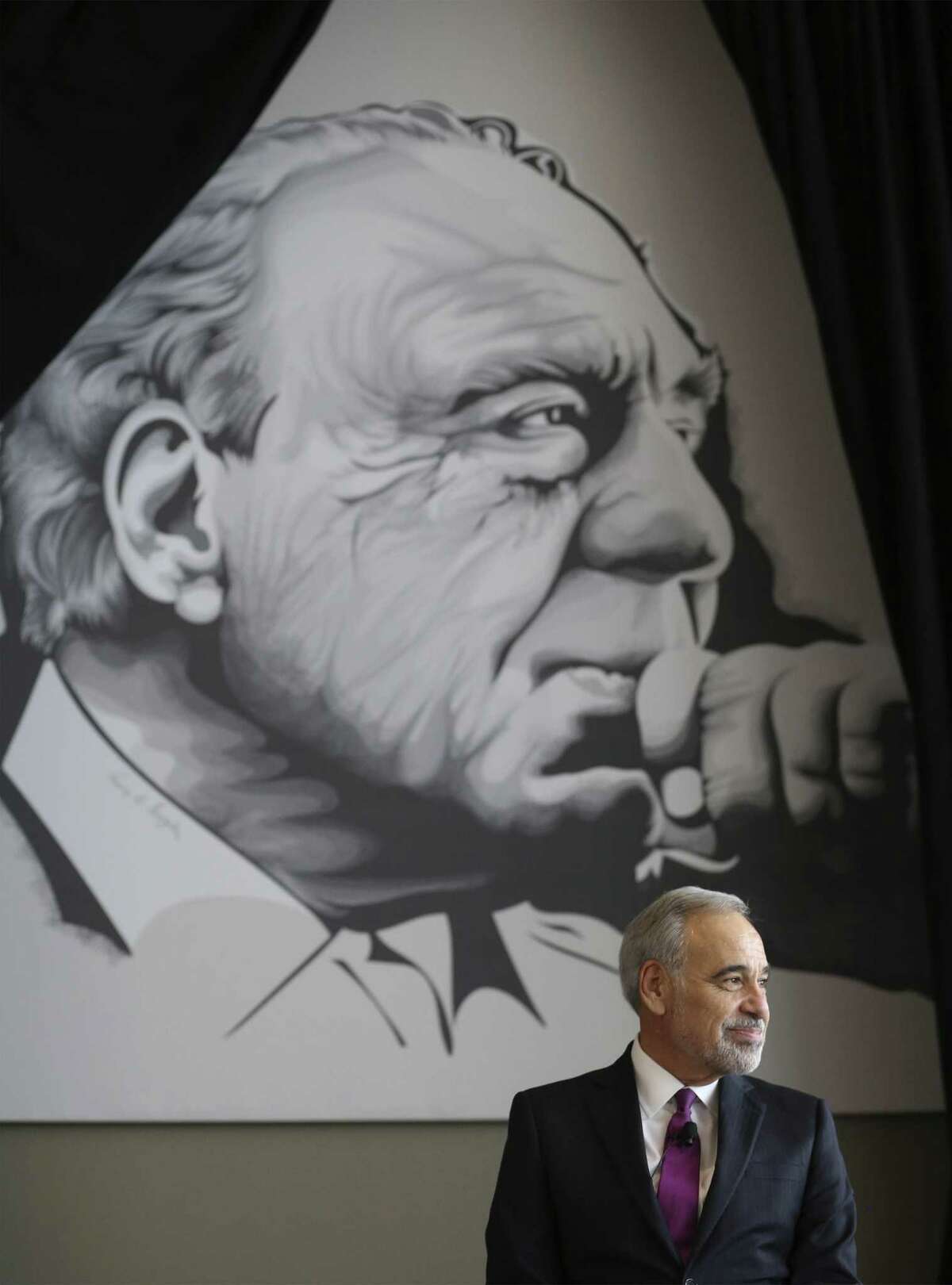 Former Congressional Representative Charlie Gonzalez sits under a mural of his father - one of San Antonio's most iconic politicians - Congressman Henry B. Gonzalez as family, friend and admirers gather at the Convention Center to see the unveiling of Gonzalez's resurrected mural on Wednesday, May 15, 2019. The original mural was painted by artist Ronald Rocha at Estela's Mexican Restaurant on the city's West Side but was painted over by building's new owners. Through an effort by businessman Louis Escareno and many others, a larger than life rendering of the mural was digitally recreated by UTSA adjunct professor and artist Analy Diego and unveiled on Wednesday evening. (Kin Man Hui/San Antonio Express-News)