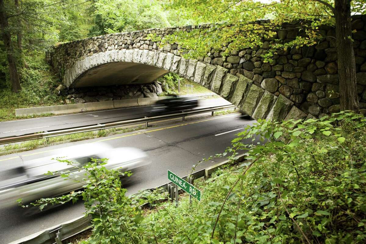 Cars travel north and south on the Merritt Parkway under the Guinea Road Bridge in Stamford.