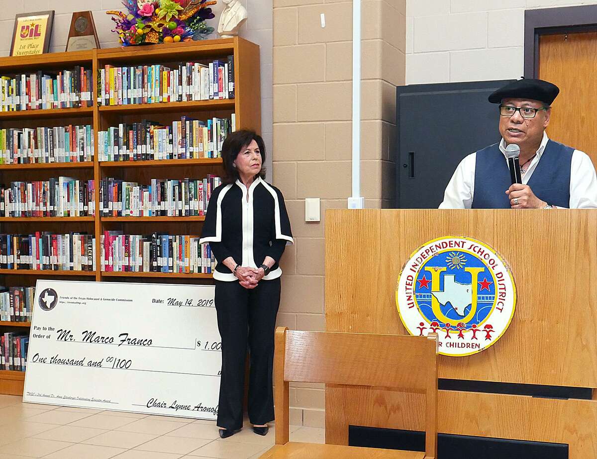 Lynne Aronoff, Commission Chair, listens as United High School ESL teacher Marco Franco speaks after being awarded the Dr. Anna Steinberger Outstanding Educator Award by The Texas Holocaust & Genocide Commission at the United High School library Tuesday. Franco was presented with a check for $1,000 and a copy of the book "The Texas Liberators: Veteran Narratives from World War II.”