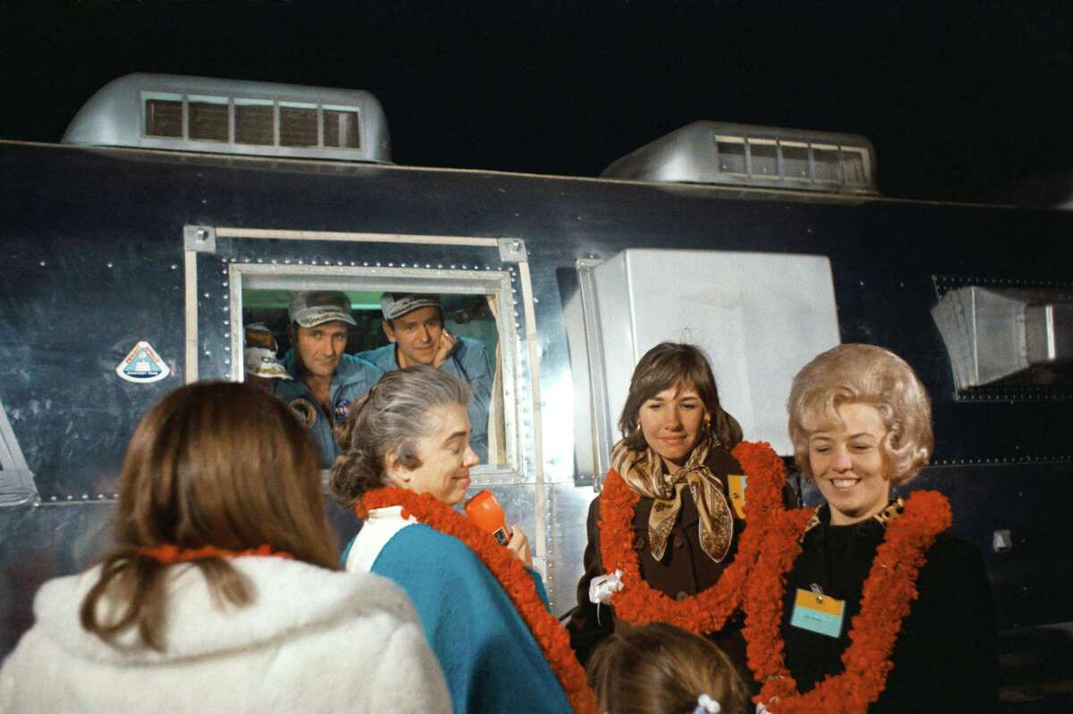 Members of the Apollo 12 astronauts are greeted by their wives and children at the front of a large crowd on hand to welcome them home. The astronauts arrived at Ellington Air Force Base aboard an Air Force C-141 transport jet in the early morning hours of Nov. 29, 1969 and remained in quarantine. Looking out the window are astronauts Charles Conrad, Richard Gordon and Alan Bean; their wives are, from left, Barbara Gordon, Jane Conrad and Sue Bean.