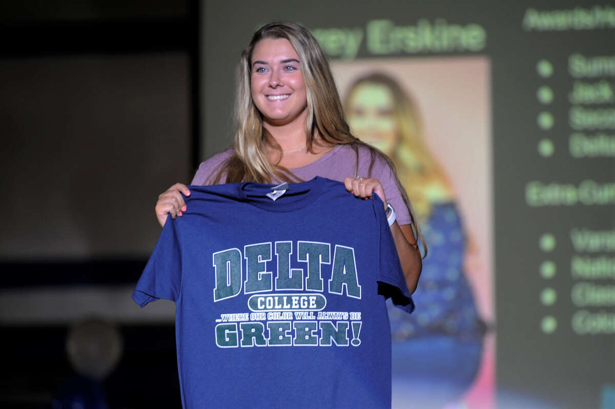Meridian High School senior Aubrey Erskine holds up a Delta College t-shirt during Decision Day at the high school on Thursday, May 16, 2019. (Ashley Schafer/ashley.schafer@hearstnp.com)
