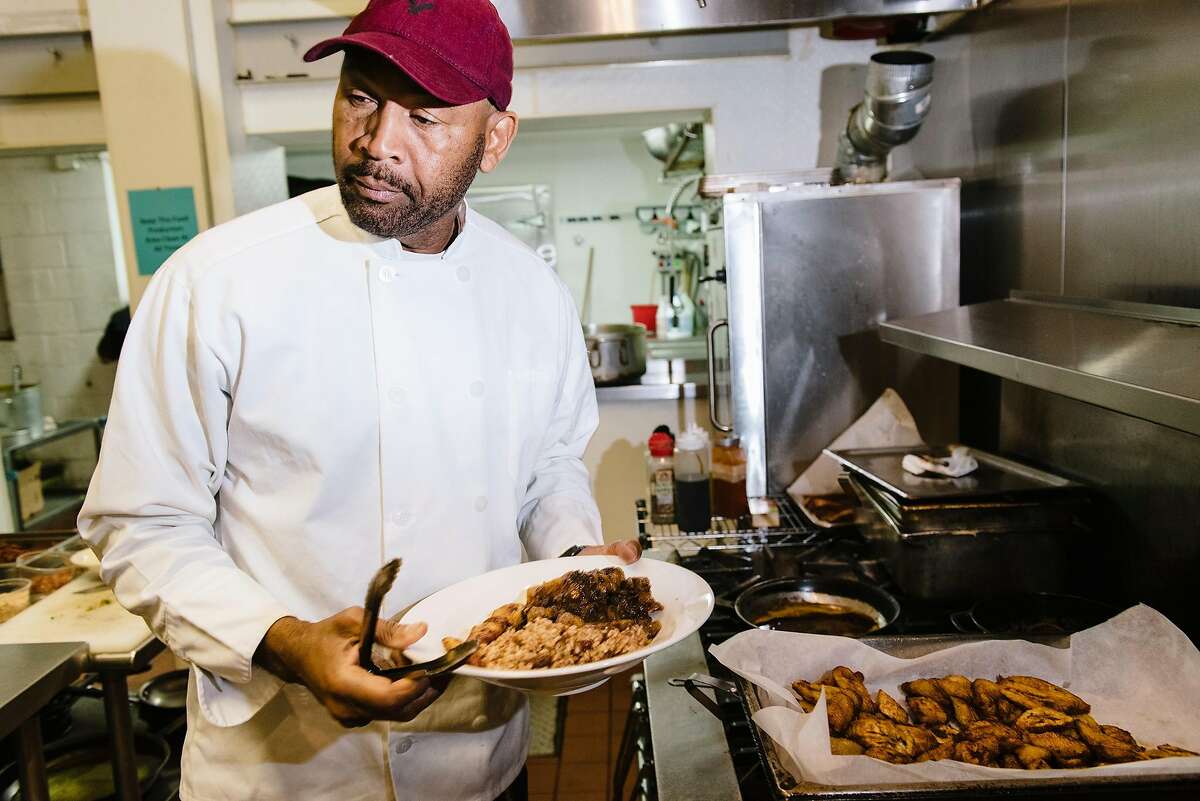 Owner Nigel Jones plates food in the kitchen of his Kingston 11 restaurant in Oakland, Calif, on Wednesday, May 15, 2019.