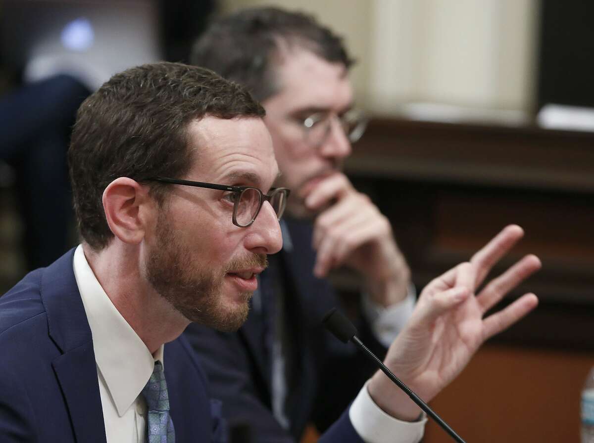 State Sen. Scott Wiener, D-San Francisco, left, discusses his housing measure during a committee hearing Wednesday, April 24, 2019, in Sacramento, Calif. Wiener's bill, SB50, that would increase housing near transportation and job hubs was approved by the Senate Governance and Finance Committee, after it was merged with SB4, a measure by State Sen. Mike McGuire, D-Healdsburg.