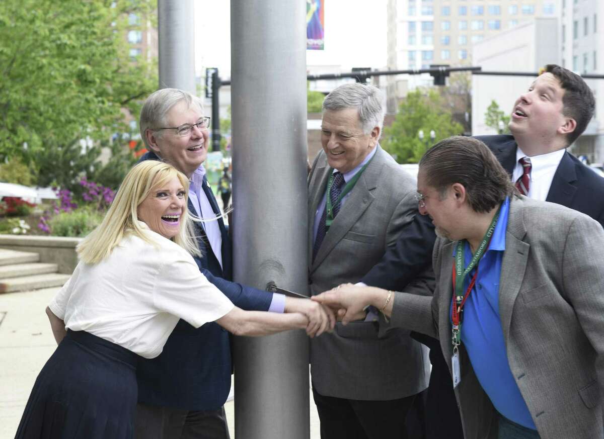 From left, City Representative Alice Liebson, Stamford Mayor David Martin, City Representative Bob Lion, City Representative Steven Kolenberg, and City Representative Eric Morson raise a flag for the first ever “Stamford Day” at the Government Center in Stamford on Thursday. The City hopes to make Stamford Day a recurring holiday to celebrate the town’s history, heritage and diversity.