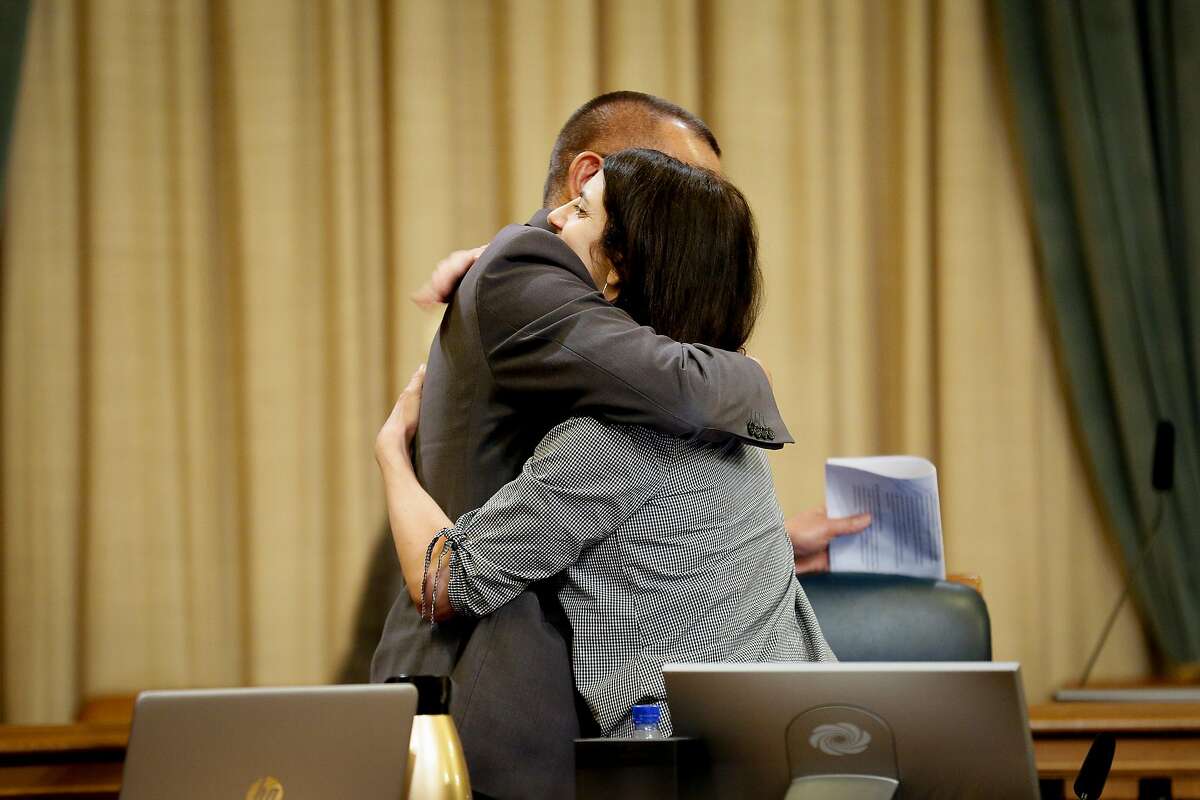 District 7 supervisor and board president Norman Yee embraces District 9 supervisor Hillary Ronen during a committee meeting at City Hall Thursday, May 16, 2019, in San Francisco, Calif. The S.F. Government Audit and Oversight Committee discussed ordinance that would close the city’s juvenile hall by the end of 2021.