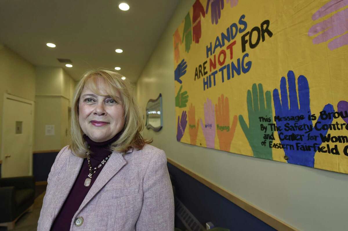 ADVANCE FOR WEEKEND EDITIONS MARCH 12-13 - In this Feb. 16, 2016 photo, Debra Greenwood is president and chief executive officer of the Center for Family Justice in Bridgeport, Conn.. The facility is undergoing a renovation to be able to provide an array of services for victims of domestic violence under one roof. She is pictured in the lobby of the center. (Cloe Poisson/Hartford Courant via AP) MANDATORY CREDIT
