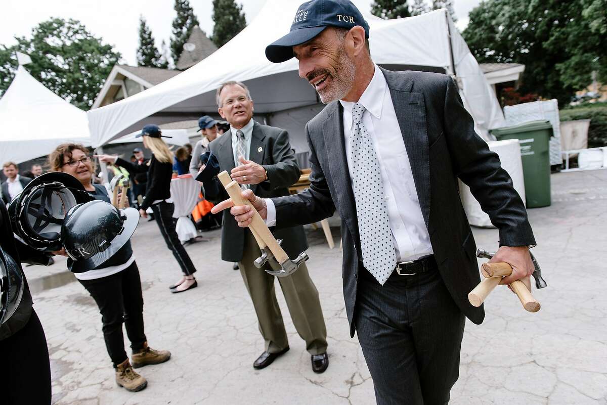 Developer Trammell Crow Residential's senior managing director Bruce Dorfman carries hammers for a ceremonial nail driving during an Alexan Downtown Danville multifamily housing development framing ceremony in Danville, Calif, on Wednesday, May 15, 2019.
