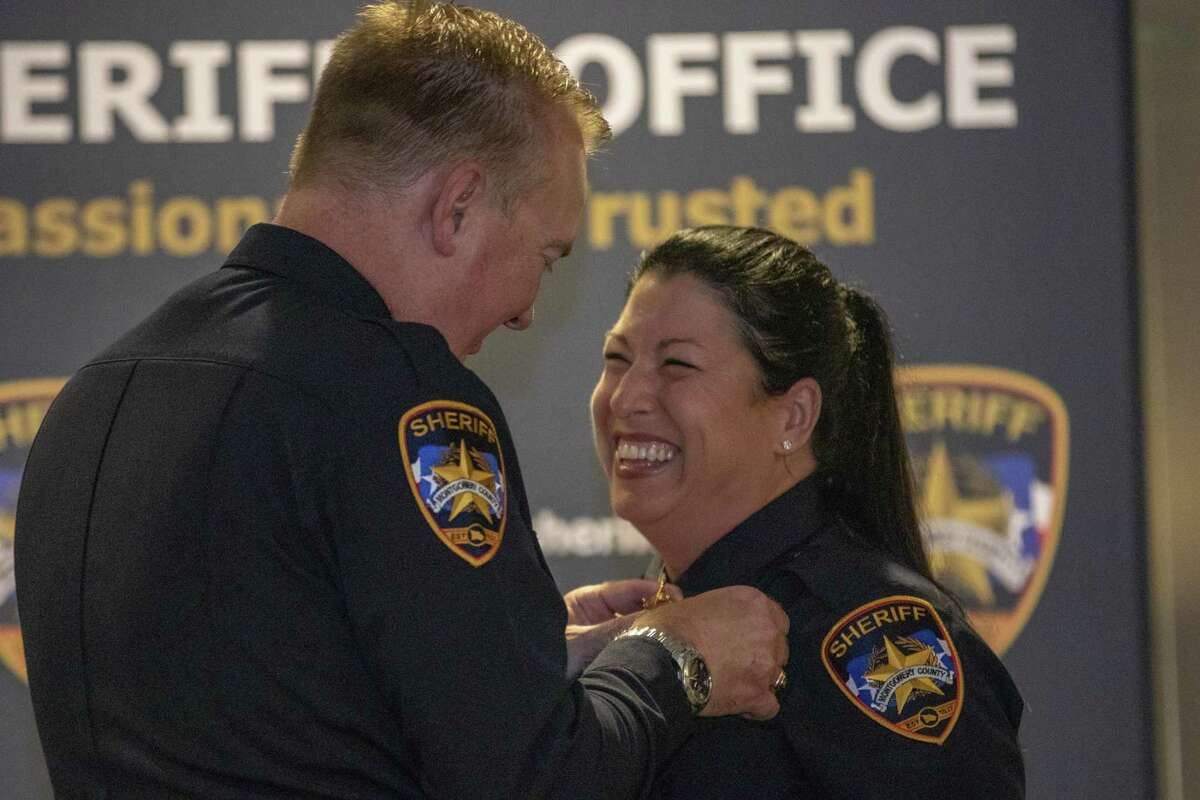 Lt. Stephanie Logan smiles as Sheriff Rand Henderson pins her badge to her uniform during a Montgomery County Sheriff’s Office promotion ceremony Thursday, May 16, 2019 at The Lone Star Convention & Expo Center in Conroe.