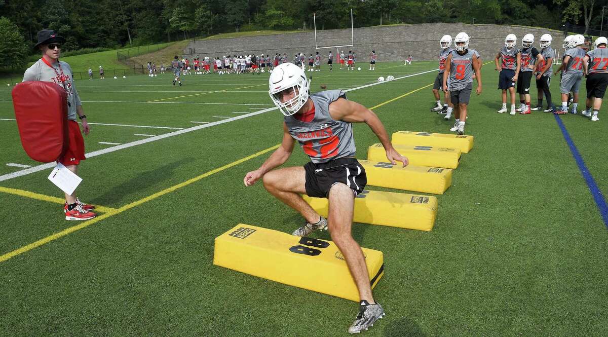 Mozi Bici (42) runs through conditioning drills on the first day of practice for the Greenwich High School football team on August 17, 2018 in Greenwich, Connecticut.