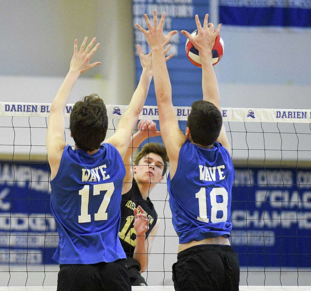 Joel Barlow's Tommy Luicido has his shot blocked by Darien's Josh de la Rivera (17) Nikoll Tinaj on Thursday. Darien won 3-0 (25-12, 25-15, 25-22), closing the regular season for both teams.