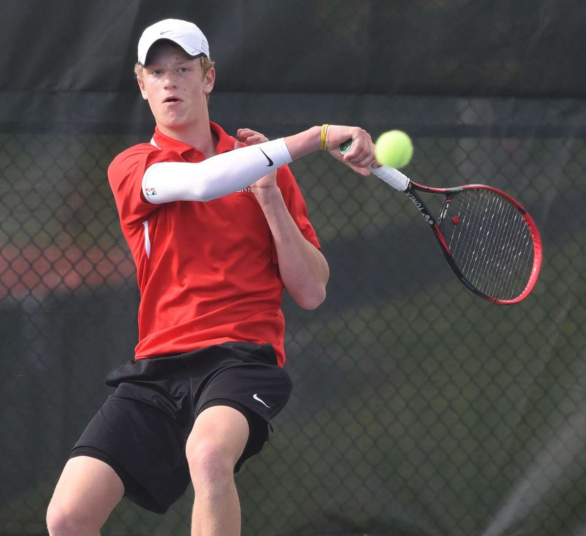 New Canaan’s Matt Brand returns a shot during his No. 1 singles match against Darien’s MIchael Karr in the FCIAC boys tennis semifinals at New Canaan High School on Thursday, May 16, 2019.