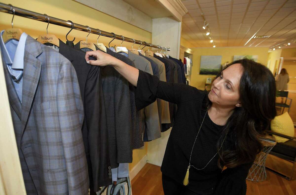 Lisa Lombardi, an independent personal Stylist for the J.Hilburn men’s clothing brand, looks through a rack at the J.Hilburn pop-up shop on May 7, 2019, at 95 Bedford St., in downtown Stamford, Conn.