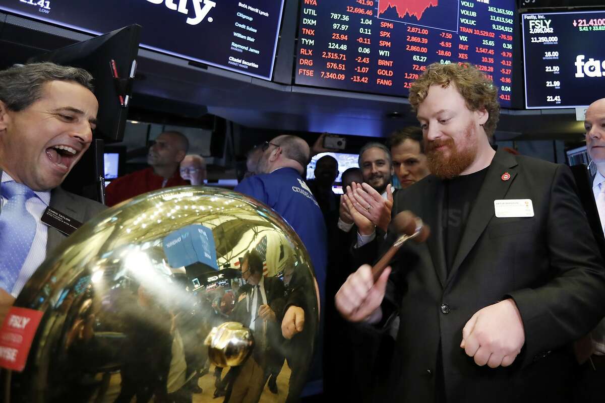Fastly Founder & CEO Arthur Bergman, right, rings a ceremonial bell on the floor of the New York Stock Exchange as his company's IPO begins trading, Friday, May 17, 2019. (AP Photo/Richard Drew)