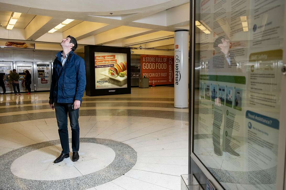 NBC reporter Sam Brock looks up at a spot in the Montgomery BART station where a kiosk was removed and that is now a naturally occurring echo chamber, in San Francisco, Calif, on Friday, May 17, 2019.
