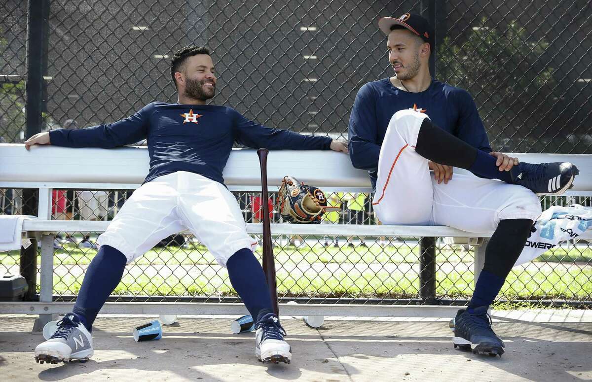 Houston Astros players Jose Altuve, left, and Carlos Correa chat while waiting to take the field for live batting practice at Fitteam Ballpark of The Palm Beaches during spring training.