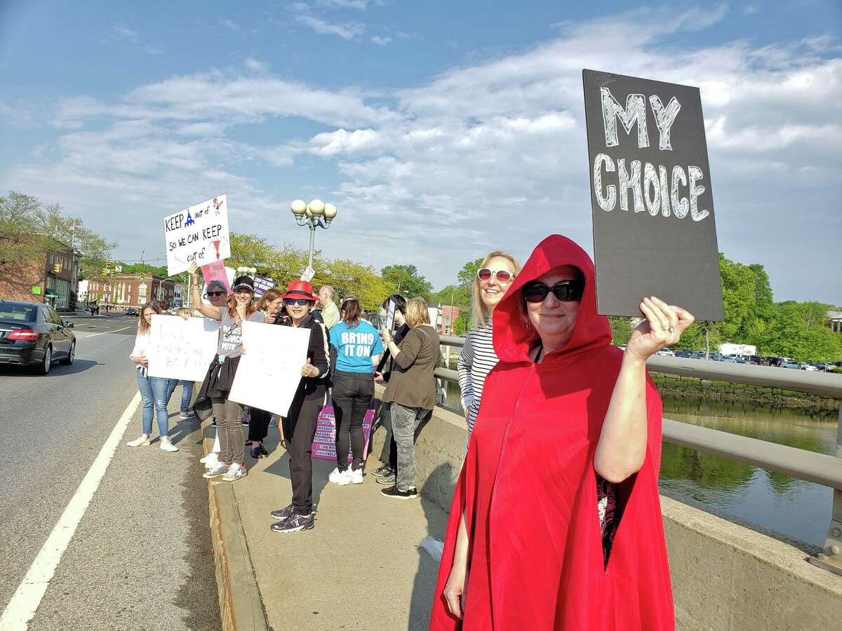 Amy Kaplan, of Westport, dons a red cloak in reference to the "Handmaid's Tale," during a protest against Alabama's abortion laws, on the Post Road bridge in Westport on May 17, 2019. “These are my sisters, my cousins, my friends across the country and we have to stand in solidarity together," she said.