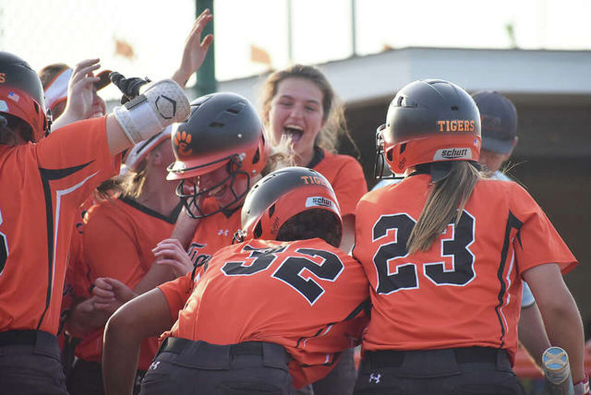 EHS center fielder Katherine Bobinski-Boyd, center, is mobbed at home plate by her teammates after a walk-off home run.
