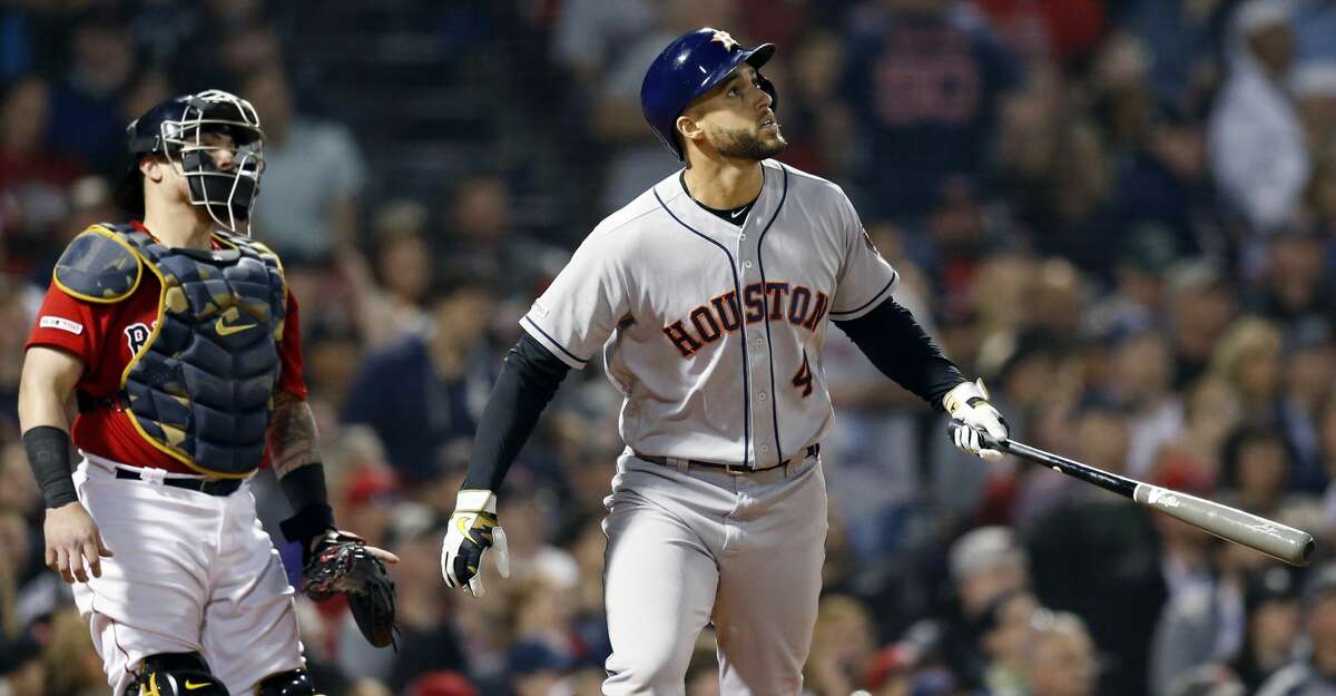 Houston Astros' George Springer (4) watches his two-run home run in front of Boston Red Sox's Christian Vazquez during the eighth inning of a baseball game in Boston, Friday, May 17, 2019. (AP Photo/Michael Dwyer)