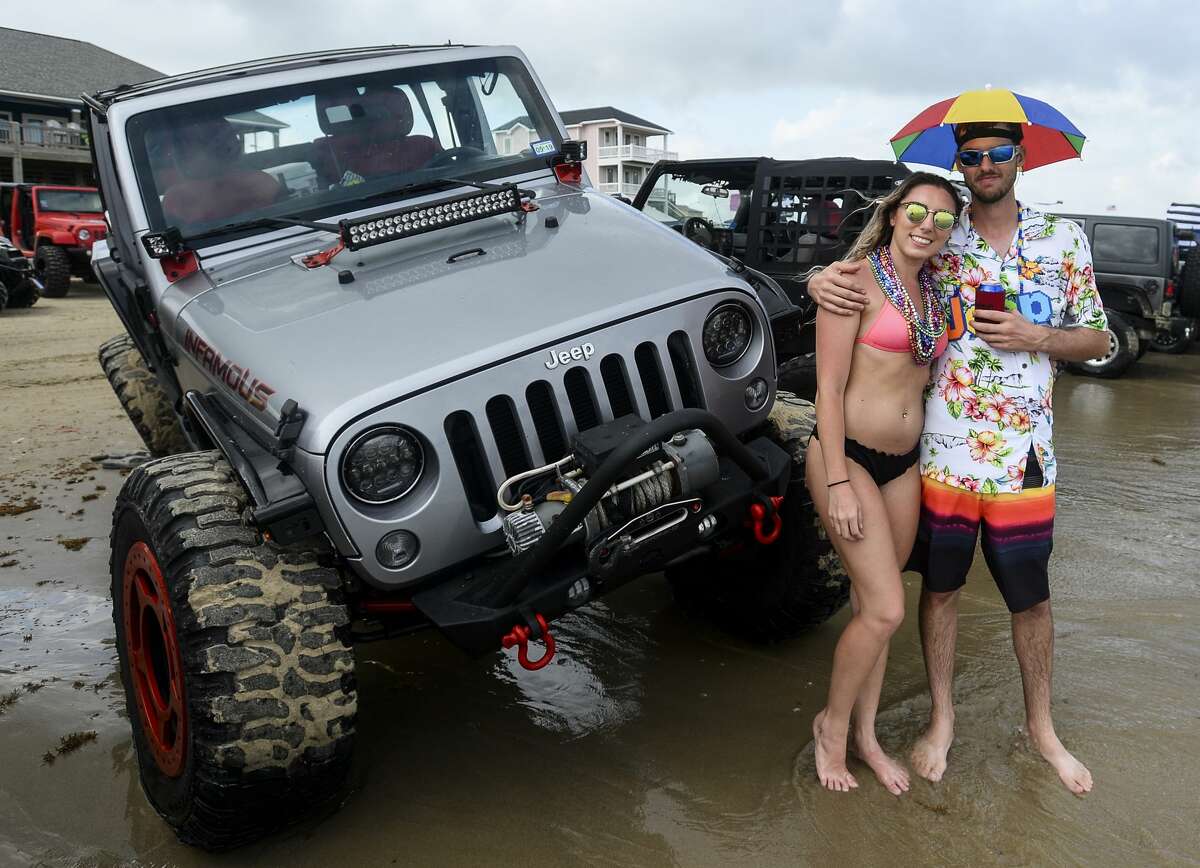 People pose with their Jeeps during the annual Go Topless Jeep weekend in Crystal Beach on Friday. Photo taken on Friday, 05/17/19. Ryan Welch/The Enterprise