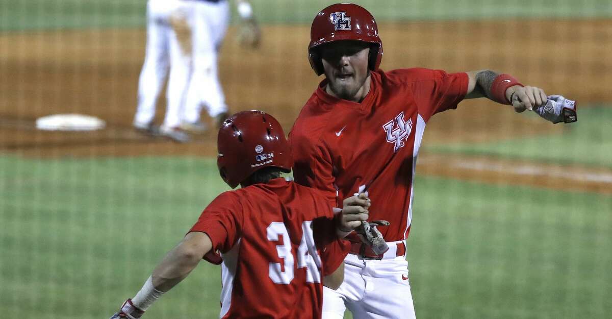 University of Houston Derrick Cherry (41) celebrates his run scored on a Rice Owls wild pitch with Kyle Lovelace (34) in the 10th inning, where Houston scored six runs on one hit during an NCAA basball game at Reckling Park, Wednesday, May 1, 2019, in Houston .