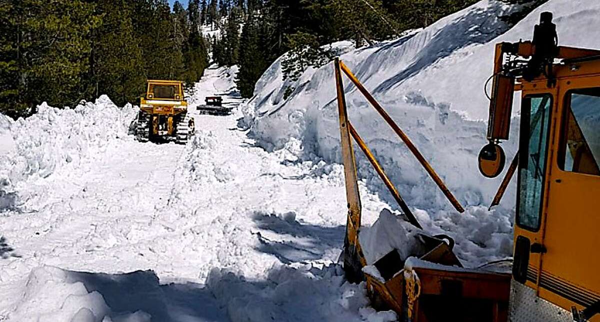 Snow plow crews work to clear Tioga Road/Highway 120 near Siesta Lake at about 8,000 feet in Yosemite National Park