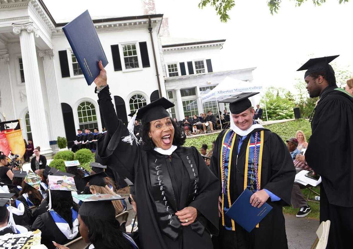 Elizabeth Loring of West Haven waves to family after receiving her degree at the Albertus Magnus College Commencement in New Haven on May 19, 2019.