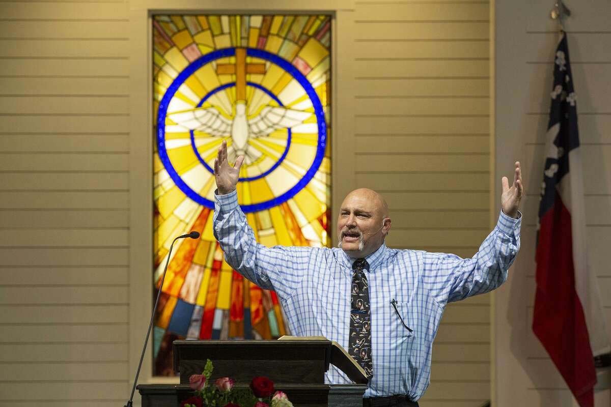 Pastor Frank Pomeroy speaks from the pulpit Sunday during the private service for church members, survivors and victims’ families, the first service held in the new building for First Baptist Church of Sutherland Springs.