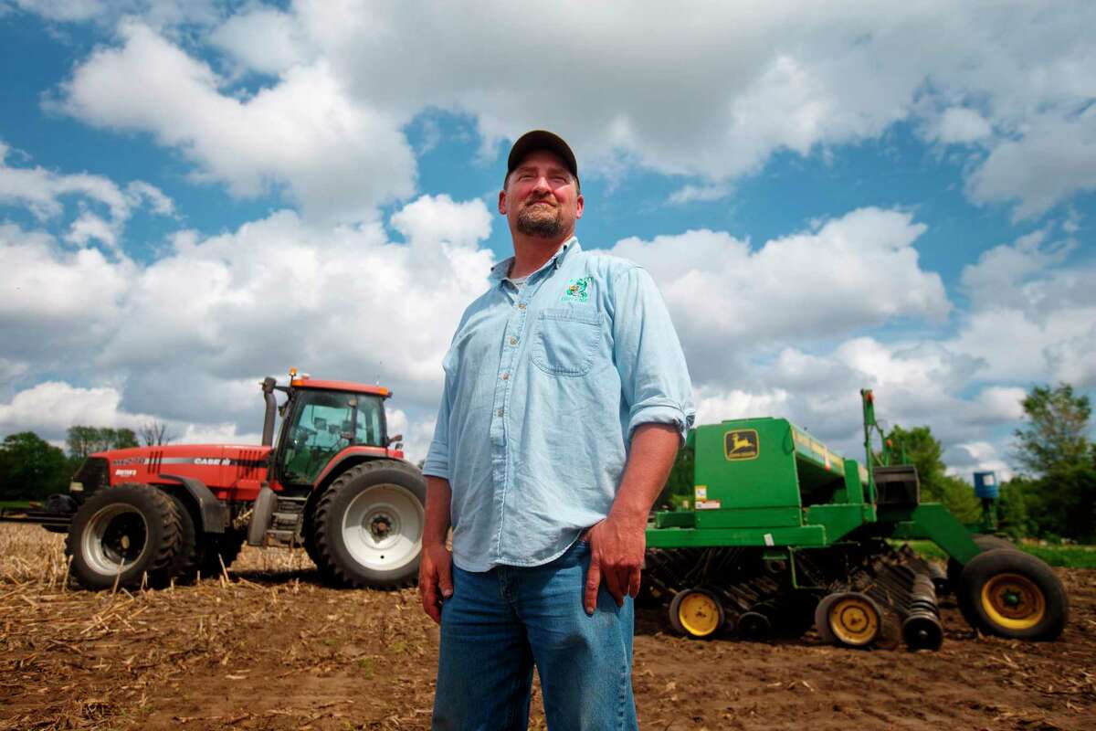 In this May 22, 2019, photo, farmer Tim Bardole pauses for a photo as he plants a field near Perry, Iowa. Donald Trump won the presidency by winning rural America, in part by pledging to use his business savvy and tough negotiating skills to take on China and put an end to trade practices that have hurt farmers for years. While the prolonged fight has been devastating to an already-struggling agriculture industry, there?s little indication Trump is paying a political price. (Zach Boyden-Holmes/The Des Moines Register via AP)